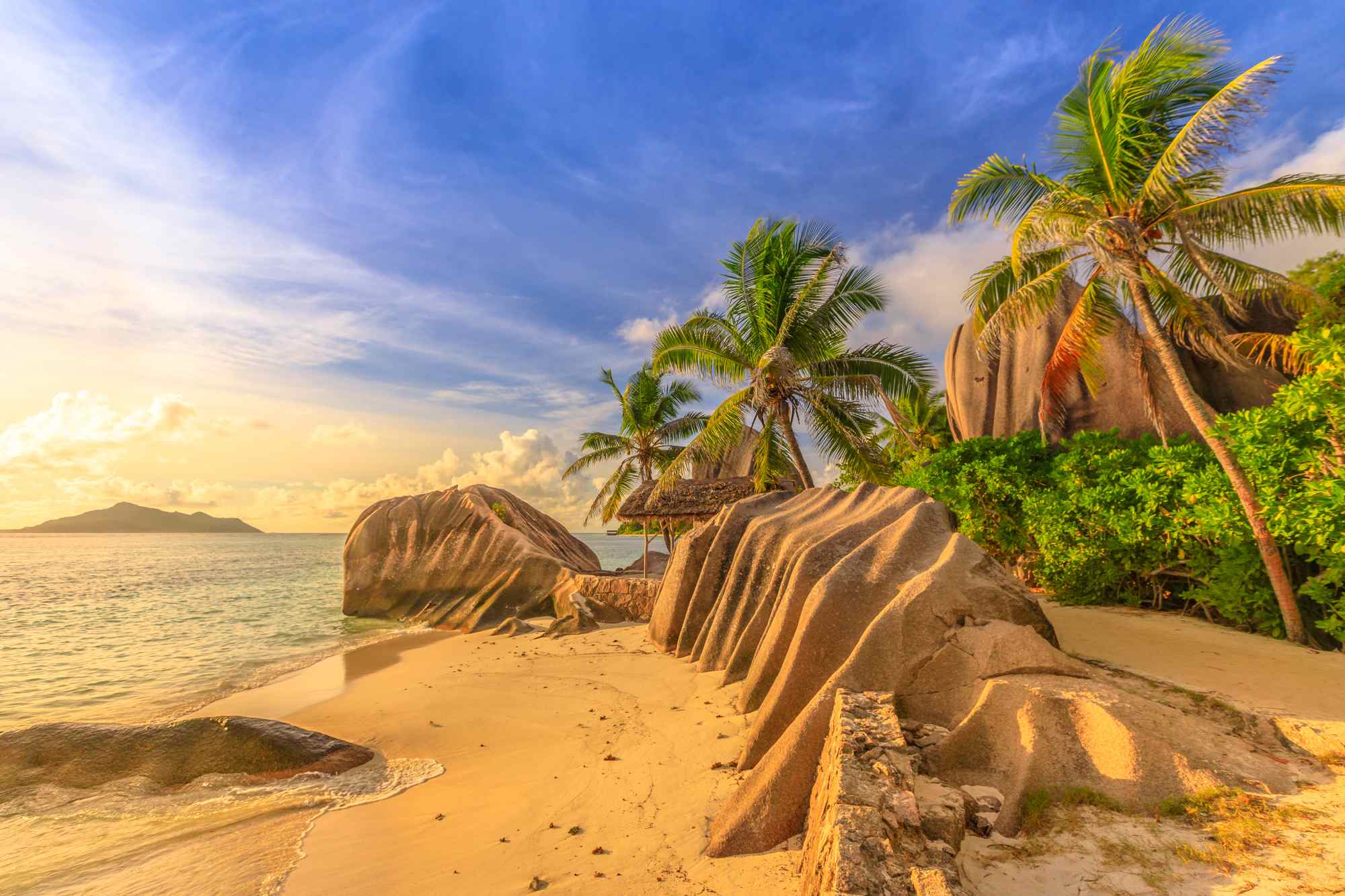 Coucher de soleil sur une plage des Seychelles avec rochers de granit et cocotiers Coucher de soleil sur une plage des Seychelles avec rochers de granit et cocotiers