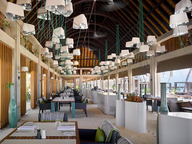 Dîner privé servi sur une terrasse sur pilotis au Velaa Private Island